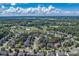 Panoramic aerial of a neighborhood, highlighting houses nestled among lush trees with lake views at 10418 Goosefoot Nw Ct, Concord, NC 28027