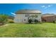 Expansive backyard featuring lush green grass and a charming two-story home with ample windows at 10418 Goosefoot Nw Ct, Concord, NC 28027