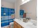 Bathroom featuring a double vanity sink, neutral wall color, and a periodic table shower curtain at 10418 Goosefoot Nw Ct, Concord, NC 28027