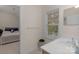 Bright bathroom featuring a white sink vanity, a large mirror, and a window with natural light at 10418 Goosefoot Nw Ct, Concord, NC 28027