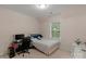 Cozy bedroom with a comfortable bed, desk and chair, bathed in natural light from the window at 10418 Goosefoot Nw Ct, Concord, NC 28027
