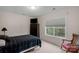 Bedroom featuring a TV, window providing natural light, and a warm inviting atmosphere at 10418 Goosefoot Nw Ct, Concord, NC 28027