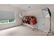 Open bonus room with a large window, a rack of clothes, and great light, perfect for hobbies or entertainment at 10418 Goosefoot Nw Ct, Concord, NC 28027