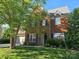 Charming brick home boasts a well-manicured lawn, beautiful landscaping, and a classic architectural design at 10418 Goosefoot Nw Ct, Concord, NC 28027