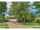 Traditional brick home with an attached two-car garage, lush landscaping, and a spacious driveway at 10418 Goosefoot Nw Ct, Concord, NC 28027