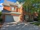 Spacious home featuring a large driveway, attached garage, and a classic brick facade at 10418 Goosefoot Nw Ct, Concord, NC 28027