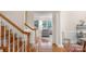 Elegant foyer featuring beautiful hardwood floors, staircase, and stylish architectural details at 10418 Goosefoot Nw Ct, Concord, NC 28027
