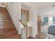 Elegant staircase and foyer featuring beautiful hardwood floors and cabinetry at 10418 Goosefoot Nw Ct, Concord, NC 28027