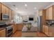 Gourmet kitchen with stainless steel appliances, center island, wooden cabinets, granite countertops and hardwood floors at 10418 Goosefoot Nw Ct, Concord, NC 28027