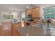 Kitchen with wooden cabinets, stainless steel appliances, granite countertops and hardwood flooring at 10418 Goosefoot Nw Ct, Concord, NC 28027
