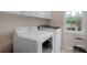 Functional laundry room featuring a modern washer and dryer set, as well as a window for natural light at 10418 Goosefoot Nw Ct, Concord, NC 28027