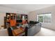 Spacious living room features a large TV, a comfortable leather couch, and built-in shelves for storage and display at 10418 Goosefoot Nw Ct, Concord, NC 28027