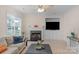 Comfortable living room with a fireplace, built-in media center and carpet flooring at 10418 Goosefoot Nw Ct, Concord, NC 28027