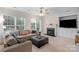 Cozy living room with a fireplace, comfortable seating, and abundant natural light at 10418 Goosefoot Nw Ct, Concord, NC 28027