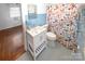 Bathroom featuring light blue tiled walls and floors with a white vanity and colorful shower curtain at 1101 Pee Dee Ave, Albemarle, NC 28001