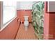 Vintage bathroom with pink tiles, patterned flooring, and a shower with a tropical curtain at 1101 Pee Dee Ave, Albemarle, NC 28001