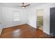 Bright bedroom featuring hardwood floors, a ceiling fan, and an ensuite bathroom at 1101 Pee Dee Ave, Albemarle, NC 28001