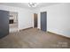 View of bedroom with neutral walls and carpeting and connecting doors at 1101 Pee Dee Ave, Albemarle, NC 28001
