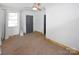 A bright bedroom with a ceiling fan, window, and neutral carpet at 1101 Pee Dee Ave, Albemarle, NC 28001