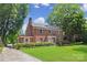 Stately brick home showcasing a beautiful lawn and traditional architectural details at 1101 Pee Dee Ave, Albemarle, NC 28001