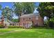 Attractive brick home featuring a lush lawn, manicured shrubs, and an inviting entrance at 1101 Pee Dee Ave, Albemarle, NC 28001