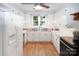 Full kitchen view featuring white cabinets, stainless steel countertops, and stainless steel appliances at 1101 Pee Dee Ave, Albemarle, NC 28001