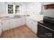 Efficient kitchen with white cabinets, stainless steel countertops, and modern appliances at 1101 Pee Dee Ave, Albemarle, NC 28001