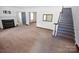Inviting living room with a fireplace and adjacent staircase leading to the upper level at 1101 Pee Dee Ave, Albemarle, NC 28001