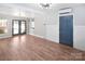 Spacious living room with wood floors, stylish lighting, and modern double doors at 1101 Pee Dee Ave, Albemarle, NC 28001