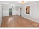 Open living room with wood floors and modern lighting, ideal for entertaining guests at 1101 Pee Dee Ave, Albemarle, NC 28001