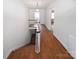 A well-lit staircase with hardwood floors and white railings at 1101 Pee Dee Ave, Albemarle, NC 28001