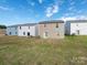 Backyard of houses with grass and modern siding at 11019 Daisy Ct, Charlotte, NC 28262