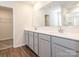 Bathroom features wood look flooring, double sinks with white countertops, and modern hardware at 11019 Daisy Ct, Charlotte, NC 28262