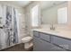 Bathroom with tub shower combo features a white vanity and updated fixtures at 11019 Daisy Ct, Charlotte, NC 28262