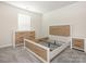 Bedroom with modern wood and white furniture and light gray carpeting at 11019 Daisy Ct, Charlotte, NC 28262