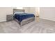 Bedroom features soft carpeting and modern grey wood bedroom furniture set with a blue comforter at 11019 Daisy Ct, Charlotte, NC 28262