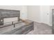 Bedroom features soft carpeting, a modern grey wood bed, and two doors at 11019 Daisy Ct, Charlotte, NC 28262