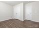 Clean bedroom with double closets, light walls, and wood-style flooring, perfect for relaxing at 11019 Daisy Ct, Charlotte, NC 28262