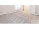 Spacious bedroom with light gray carpet and two doors at 11019 Daisy Ct, Charlotte, NC 28262