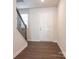 Entryway features hardwood floors, stairs with black metal railing and white trim at 11019 Daisy Ct, Charlotte, NC 28262