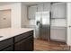 Modern kitchen featuring a stainless steel refrigerator, granite countertops, and stylish gray cabinets at 11019 Daisy Ct, Charlotte, NC 28262