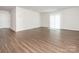 Open living room with wood flooring, white walls, and sliding glass doors provides ample natural light at 11019 Daisy Ct, Charlotte, NC 28262