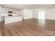 Open concept kitchen and living room with hardwood floors and bright lighting at 11019 Daisy Ct, Charlotte, NC 28262