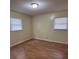Bedroom with hardwood floors and two windows at 1120 Mcintyre Rd, Wingate, NC 28174