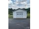 Detached white garage with roll up door situated on a large lot at 1120 Mcintyre Rd, Wingate, NC 28174