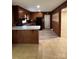 Eat-in kitchen featuring wood-paneled walls, tile floor and black appliances at 1120 Mcintyre Rd, Wingate, NC 28174