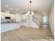 Open floor plan featuring a view of the kitchen with stainless steel appliances and center island at 11455 Prosperity Church Rd, Huntersville, NC 28078