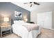 Comfortable bedroom featuring a ceiling fan, art, lamps, and a cozy bed at 119 Steinbeck Way # E, Mooresville, NC 28117