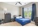 Stylish bedroom with window, ceiling fan, closet, and dark colored furniture at 119 Steinbeck Way # E, Mooresville, NC 28117