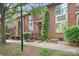 Charming red brick townhome with well-maintained landscaping, and a welcoming entrance at 119 Steinbeck Way # E, Mooresville, NC 28117